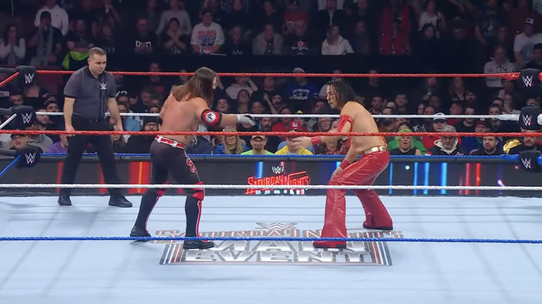 Styles and Nakamura staring one another down in the ring