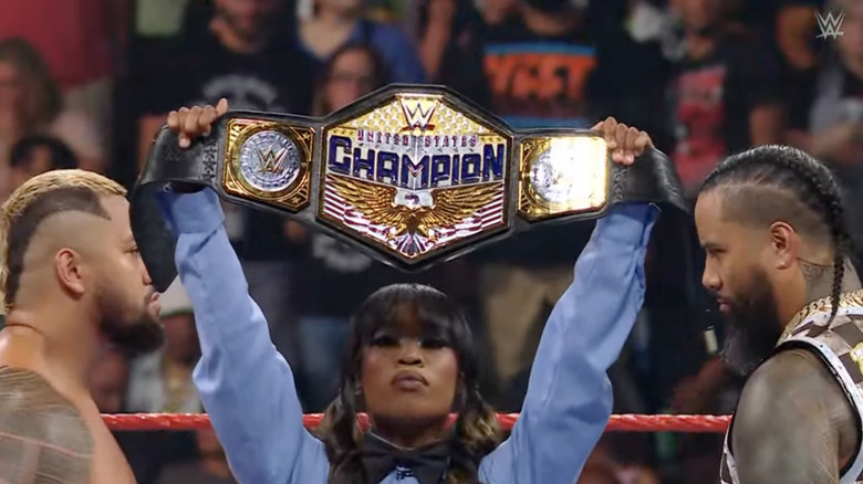 Sikoa and Jimmy staring each other down as the referee holds up the US title belt