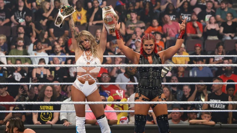 Sol Ruca holds up the WWE Speed and Women's North American Championships alongside tag team partner Zaria after a victory on "WWE SmackDown."