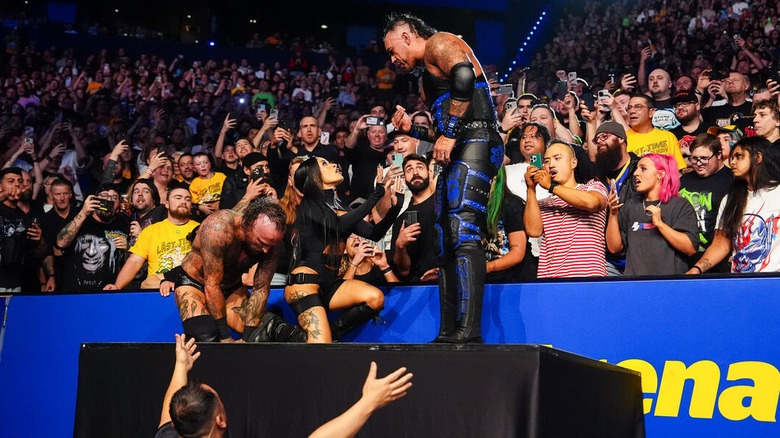 Zelina Vega puts herself between Aleister Black and Damian Priest outside the ring on "WWE SmackDown"