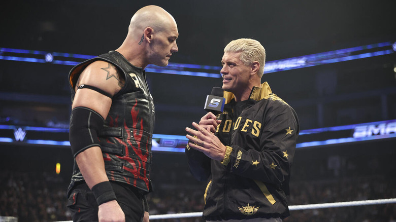 Cody Rhodes with a microphone speaking to Baron Corbin in the ring on "WWE SmackDown"