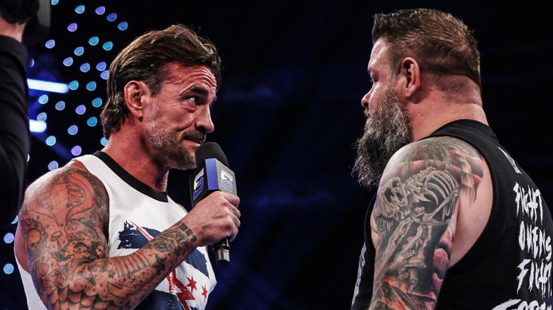CM Punk and Kevin Owens exchange words in the ring