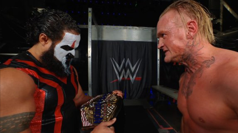 Tama Tonga holds Ilja Dragunov's title belt