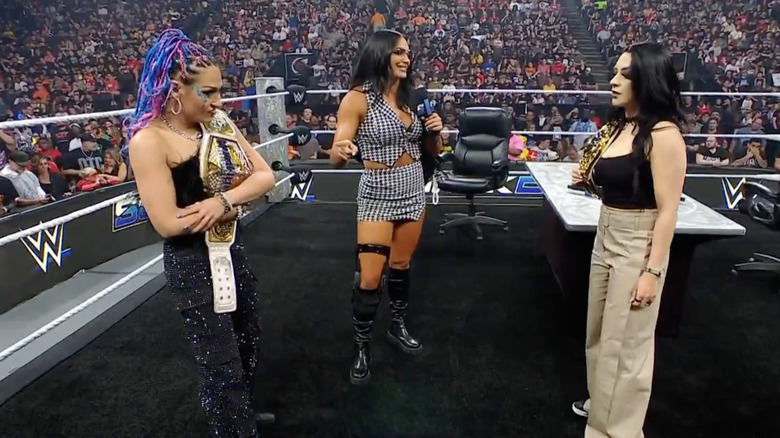 Giulia and Kianna James talking to Vaquer in the ring