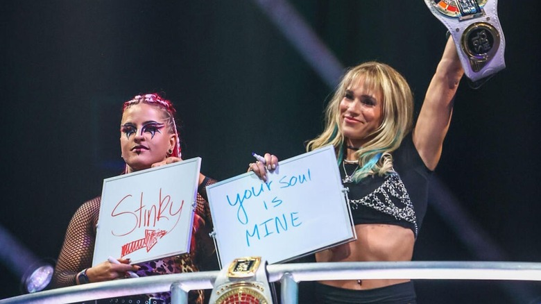 Sol Ruca and Zaria hold up funny signs