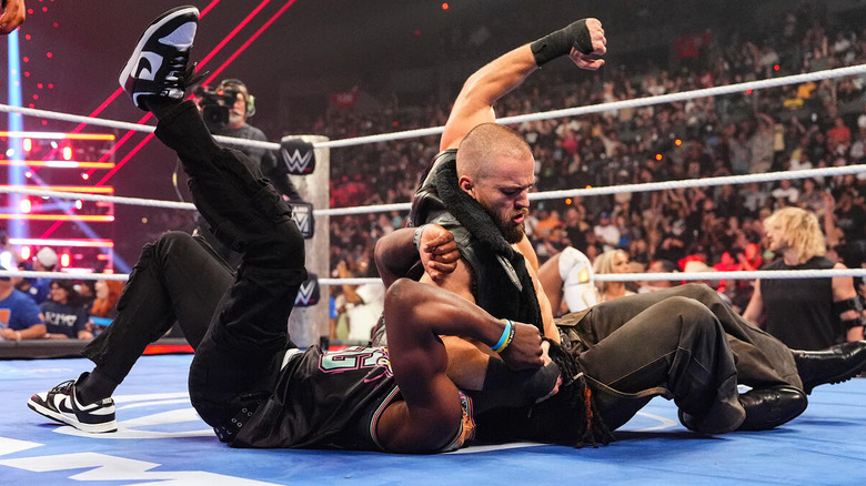 Austin Theory punches Je'Von Evans on the mat on "WWE SmackDown"