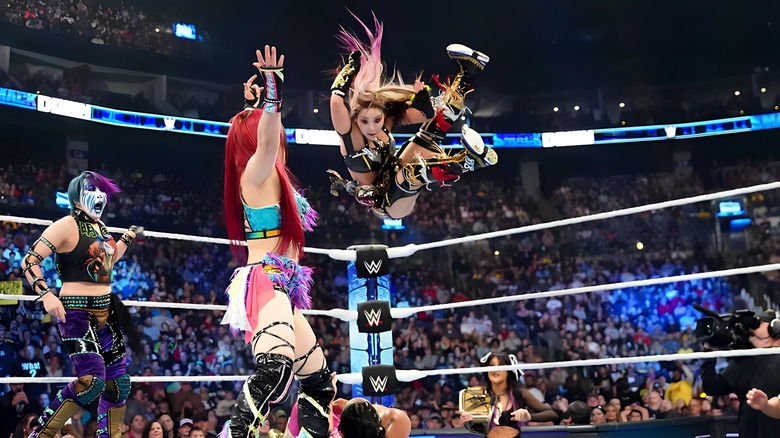 Kairi Sane drops an elbow on Bianca Belair while Damage CTRL looks on