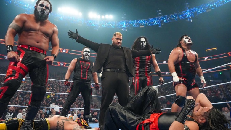 Solo Sikoa and the MFTs stand over Shinsuke Nakamura and Rey Fenix after a brawl in the ring on "WWE SmackDown."