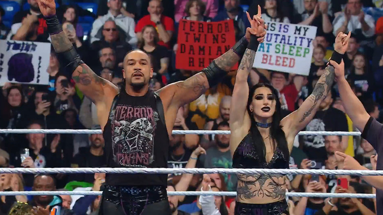 Damien Priest and Rhea Ripley celebrate after their match.