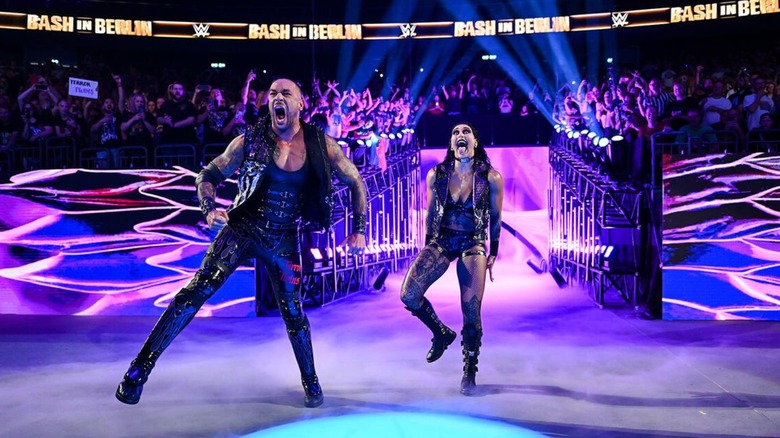 Damian Priest and Rhea Ripley pose on the stage before a match at WWE's Bash in Berlin event.