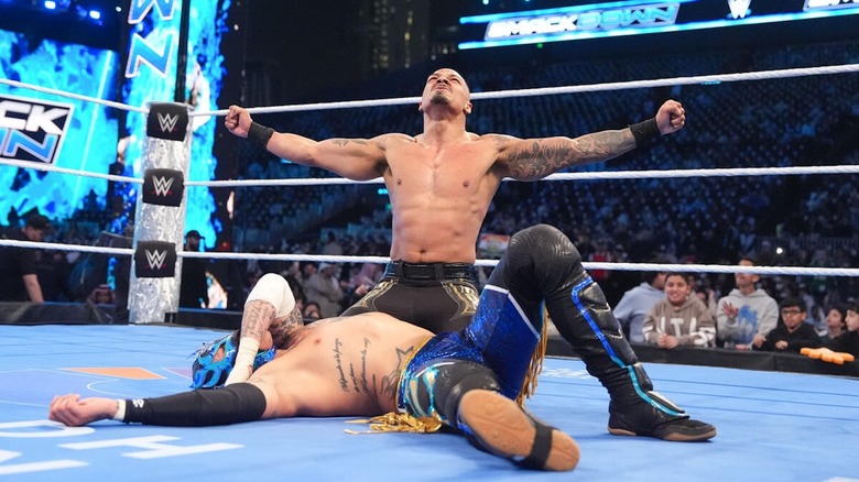 Carmelo Hayes poses over Rey Fenix on "WWE SmackDown"