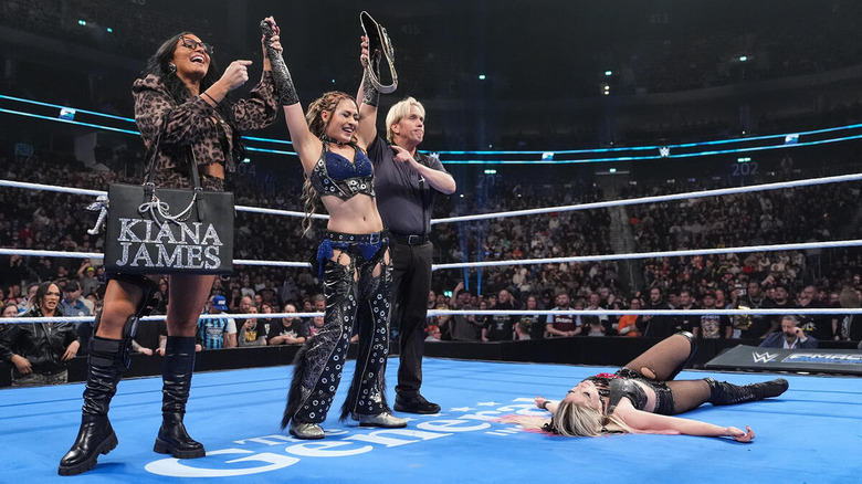Giulia holds up the women's U.S. title while standing next to Kiana James and above Alexa Bliss on "SmackDown"