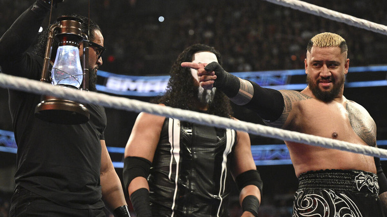 Solo Sikoa points at a lantern held by Tama Tonga on "WWE SmackDown"