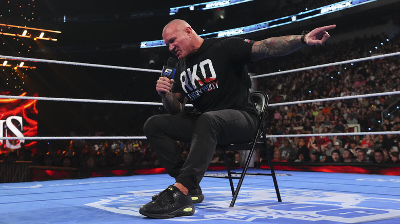 Randy Orton sits with arm pointed and microphone in hand on "WWE SmackDown"