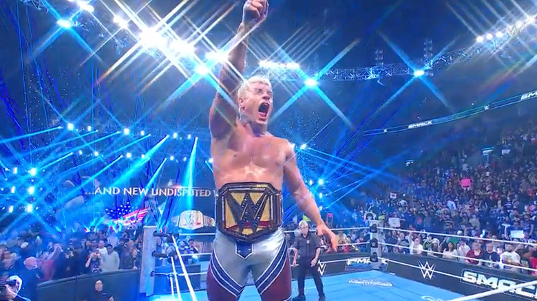 Cody Rhodes raises his arm to the sky while wearing the WWE Championship on "SmackDown"