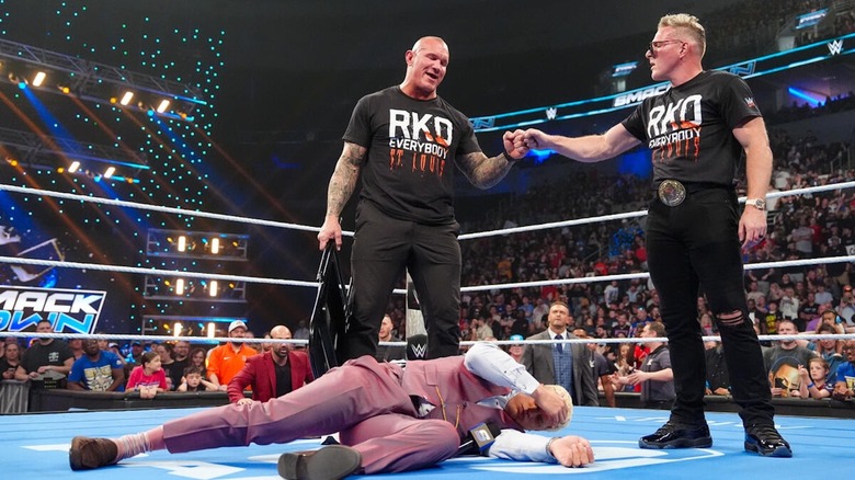 Randy Orton and Pat McAfee fist-bump over a fallen Cody Rhodes on "WWE SmackDown"