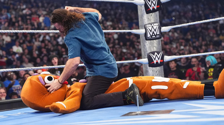 Sami Zayn hits mounted punches on a gingerbread man costume on "WWE SmackDown"