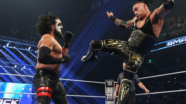 Damian Priest hitting a cyclone kick on Tama Tonga