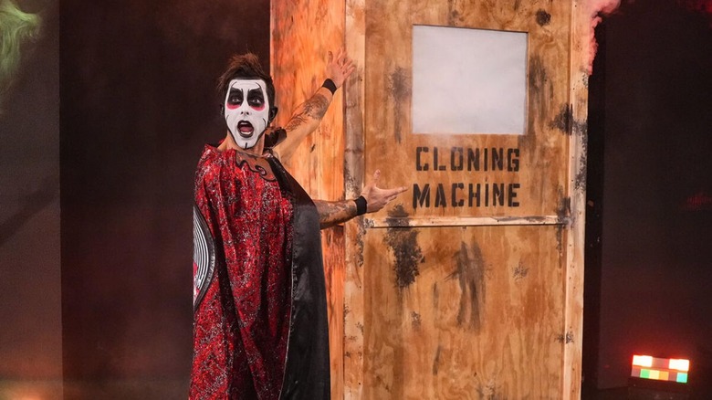 Danhausen gestures toward his "cloning machine," the crate he arrived to WWE in, during his match against The Miz and Kit Wilson at WWE Backlash.