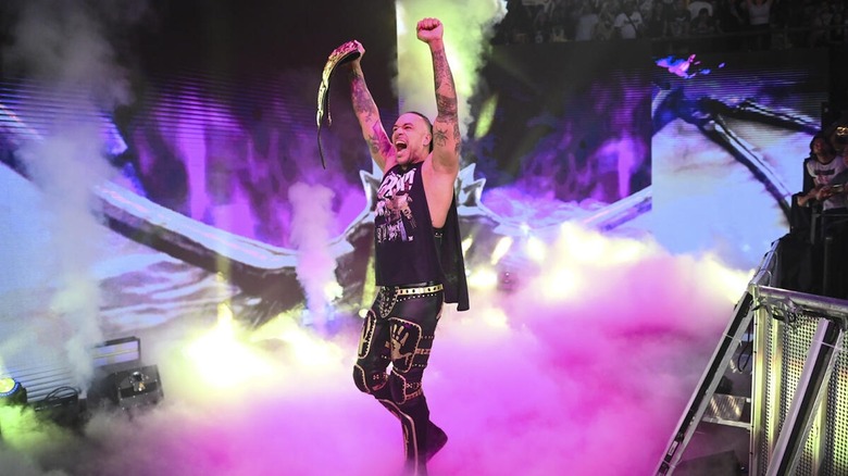 Damian Priest makes his entrance with his arms aloft on "WWE SmackDown"