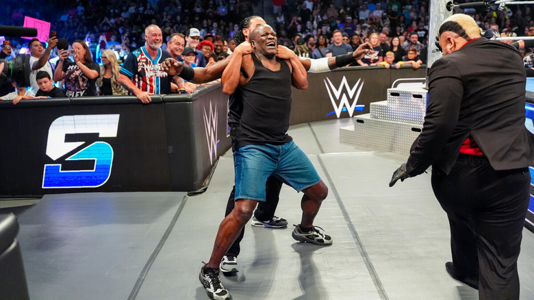 Tama Tonga holds R-Truth so Solo Sikoa can spike him on "WWE SmackDown"