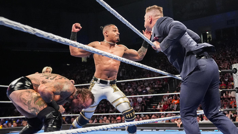 Carmelo Hayes mistakenly hits The Miz as Aleister Black dodges.