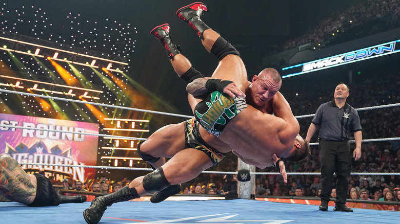 Orton delivering a Scoop Powerslam to LA Knight