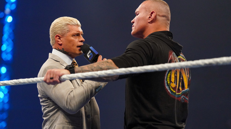Cody Rhodes speaking into the microphone with Randy Orton on "WWE SmackDown"