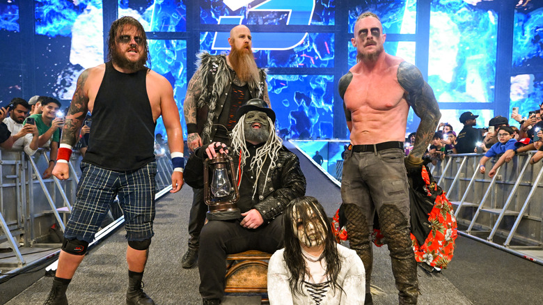 Joey Gacy, Erick Rowan, Uncle Howdy, Nikki Cross and Dexter Lumis of the Wyatt sicks enter the arena during SmackDown at Kingdom Arena on June 27, 2025 in Riyadh, Saudi Arabia.