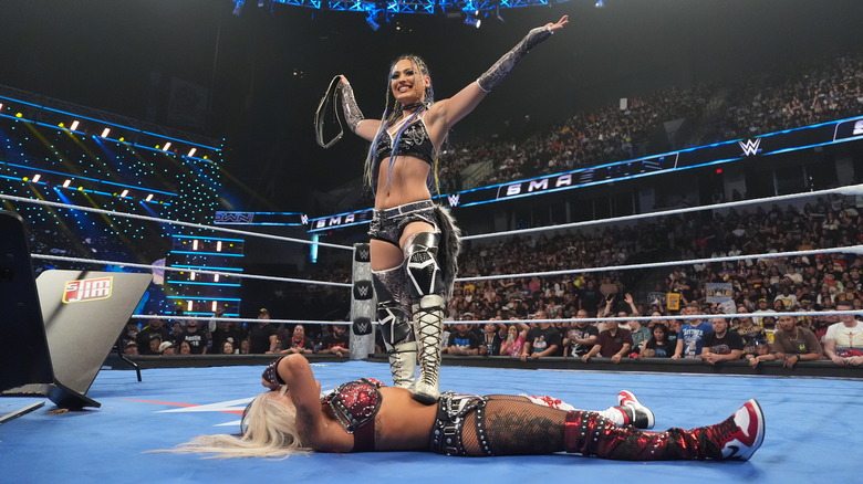 Giulia standing over Zelina Vega, holding up the women's US title on "WWE SmackDown"