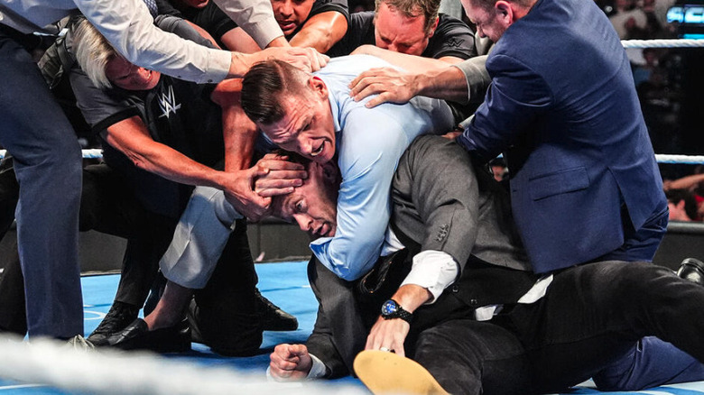 GUNTHER with Nick Aldis in a sleeper hold while officials try to drag him off on "WWE SmackDown"