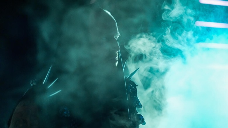 Aleister Black makes his entrance through swirling smoke on 