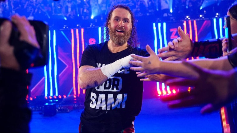 Sami Zayn slaps hands with fans as he heads down the ramp to the ring for his tag team match with GUNTHER at Saturday Night's Main Event on July 18, 2026.