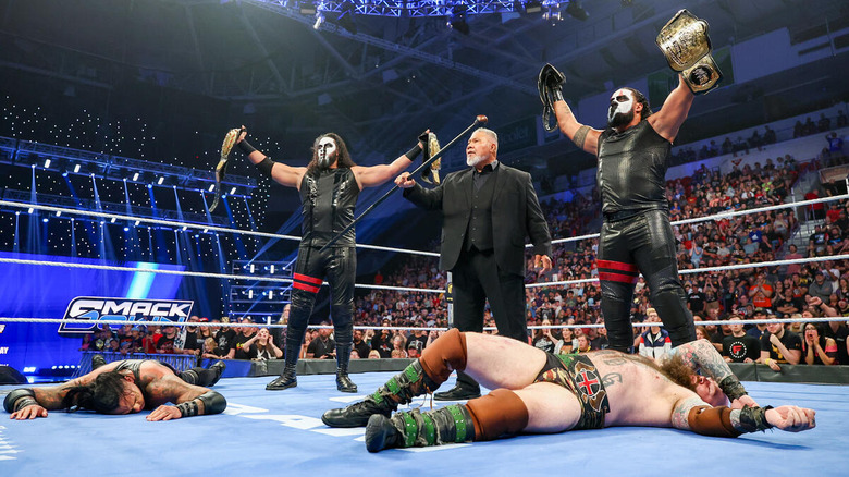 MFT pose with the WWE tag title belts and Haku on "WWE SmackDown"