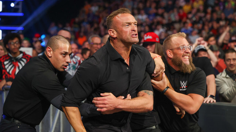 Nick Aldis being held back by security on "WWE SmackDown"