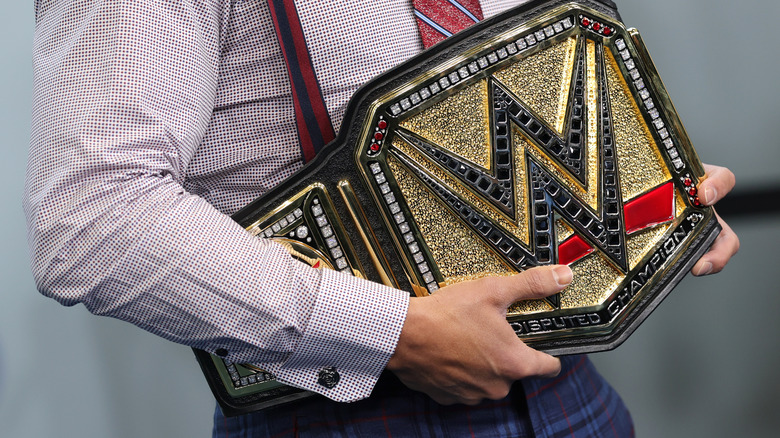 Cody Rhodes holds the WWE Title belt