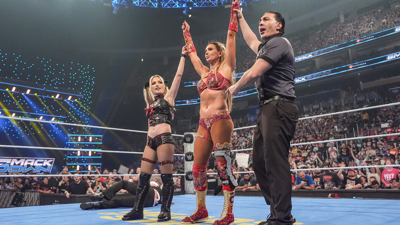 Alexa Bliss and Charlotte Flair with their hands raised