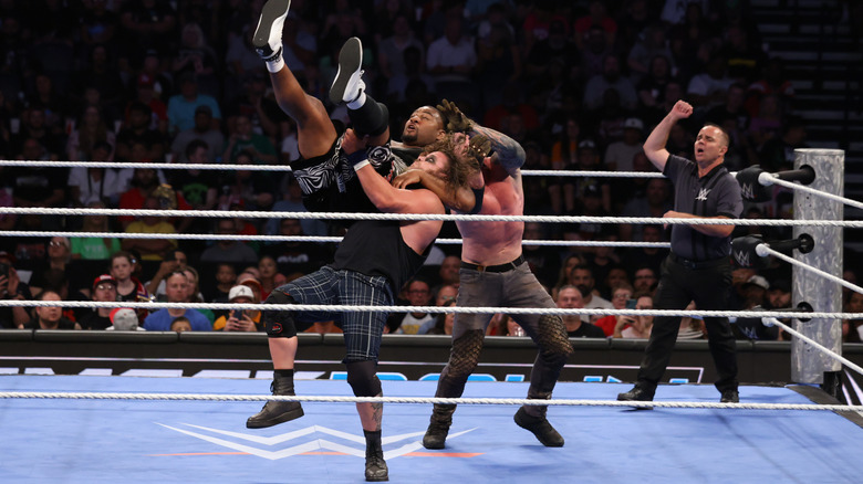 Joe Gacy and Dexter Lumis double team Angelo Dawkins