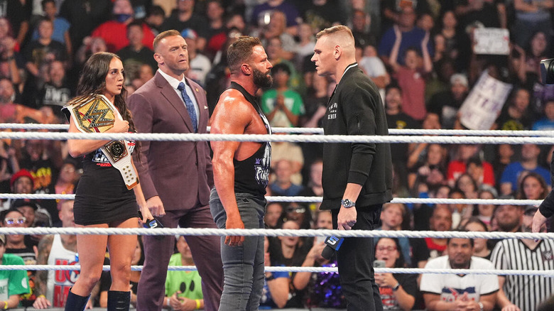 Matt Cardona confronts GUNTHER in the ring on "WWE SmackDown" while Chelsea Green and Nick Aldis look on