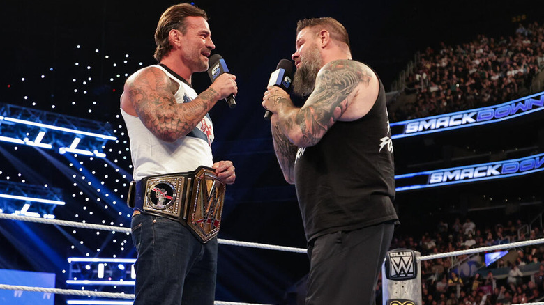 CM Punk and Kevin Owens speaking to each other in the ring on "WWE SmackDown"