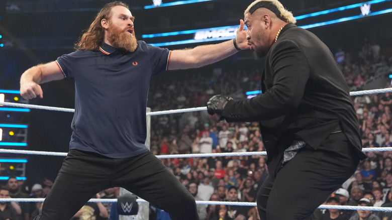 Sami Zayn punching Solo Sikoa in the ring on "WWE SmackDown"
