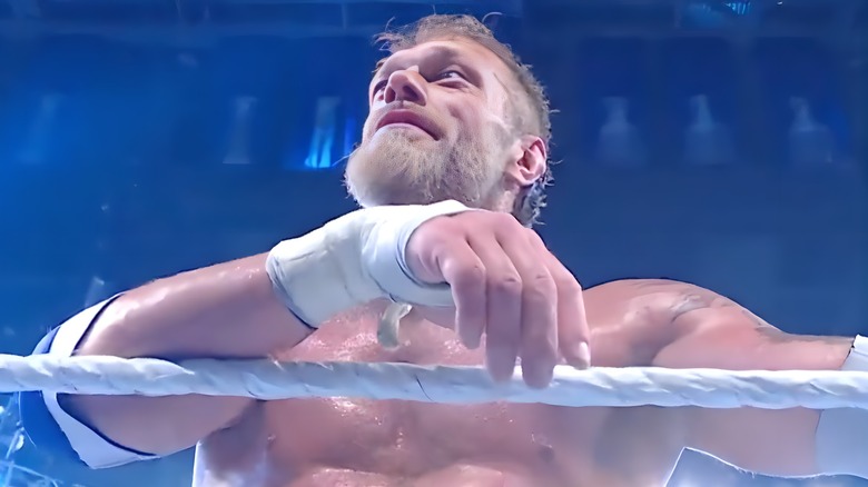 Edge resting his arm on the top rope