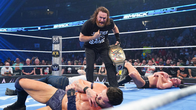 Sami Zayn stands over a fallen Finn Balor and GUNTHER holding the Undisputed WWE Championship while pointing at himself on "WWE SmackDown"