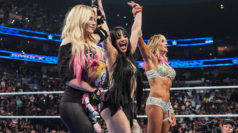 Tatum Paxley celebrates between Alexa Bliss and Charlotte Flair on "WWE SmackDown"