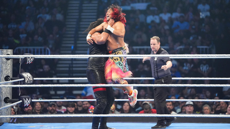 Talla Tonga lifting Kyoki by the throat in the ring on "WWE SmackDown"