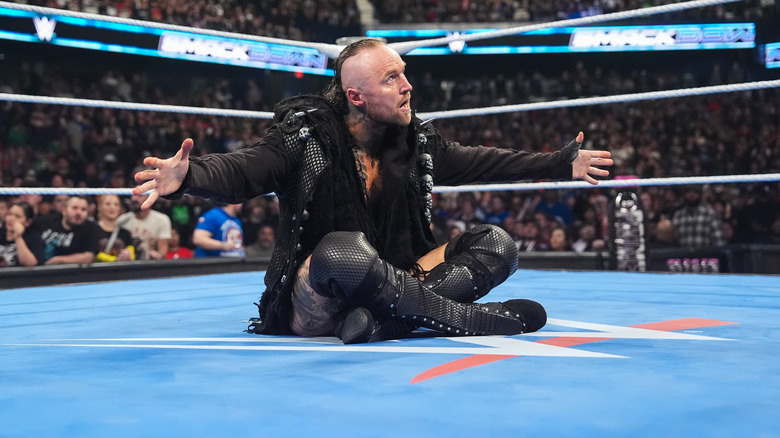Aleister Black sitting in the ring