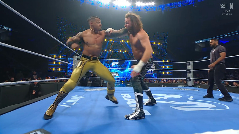 Hayes firing off right hands on Zayn in the ring