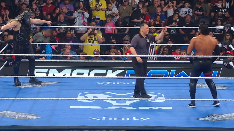 Howdy and Tama staring down one another in the ring