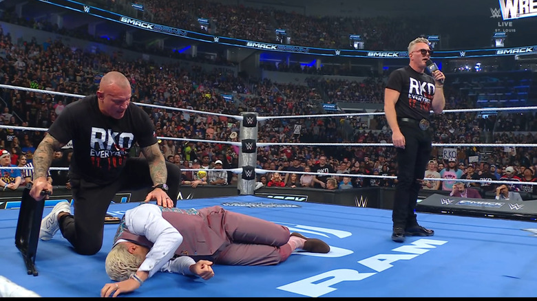 Orton and McAfee standing over Rhodes