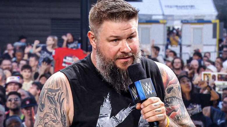 Owens speaking on the microphone during a panel